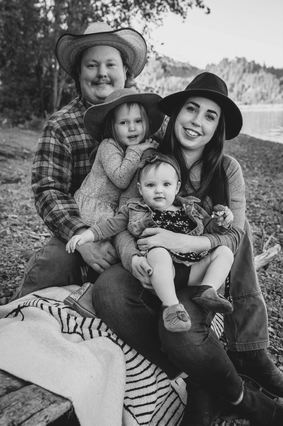 Alex and Brittany Jacobson with their two daughters beside the river